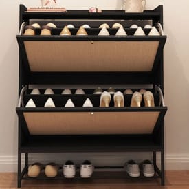 A black three-tiered shoe cabinet with beige fabric back panels, holding a collection of high heels and flat shoes on each shelf.