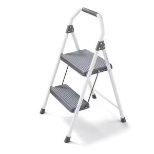 A white two-step ladder with gray, non-slip steps and a padded handle for stability.