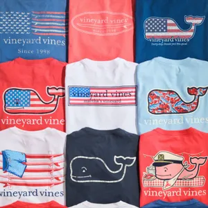 A collection of nine Vineyard Vines t-shirts featuring various designs, including patterns with American flags, whales, and nautical themes, displayed in a 3x3 grid layout.