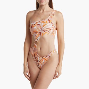 One-shoulder, cut-out swimsuit with a tropical print.