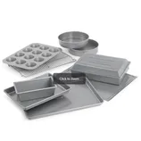 Baking set with a muffin tin, loaf pan, round cake pans, baking sheets, cooling rack, and a covered rectangular pan.