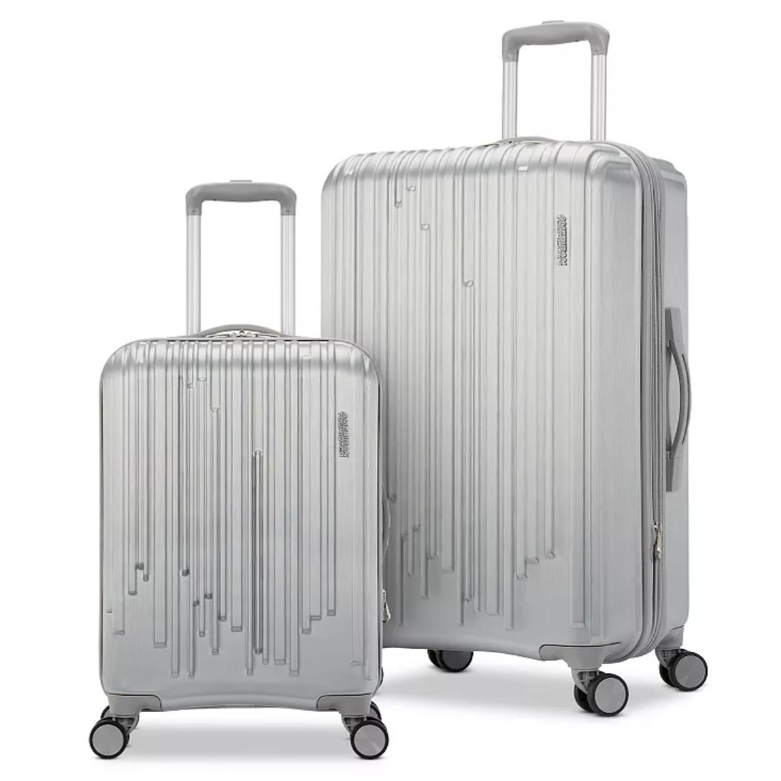 Two silver suitcases with vertical line designs, featuring telescopic handles and four-wheel spinners.