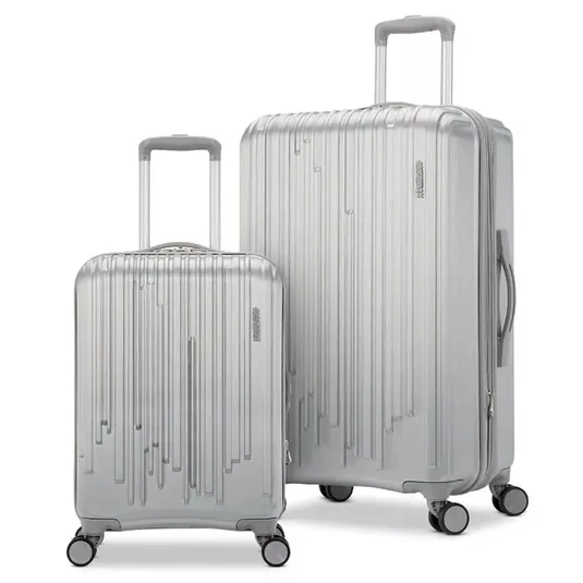 Two silver suitcases with vertical line designs, featuring telescopic handles and four-wheel spinners.