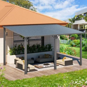 A modern outdoor patio features a metal-roofed pergola over wooden decking with cushioned seating, a low coffee table, and surrounding greenery.