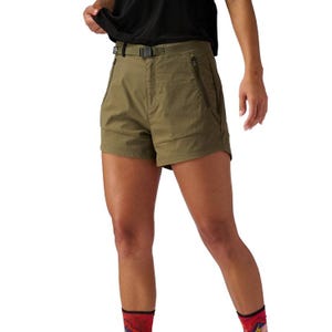 Olive green hiking shorts featuring a belt and zippered pockets, paired with a black top and vibrant red socks with designs.