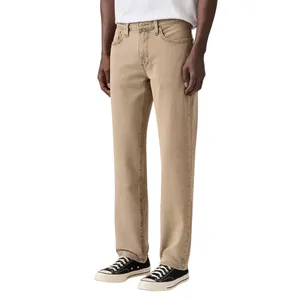 Beige straight-leg jeans paired with black and white canvas sneakers on a male model.