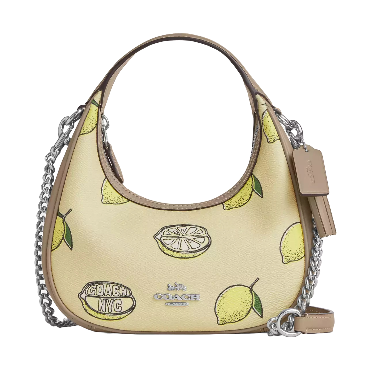 Coach Carmen Bag features a lemon print on a light background with silver chain detailing and a leather strap. It's accented by a \“Coach NYC\“ logo, adding a playful touch to the design.