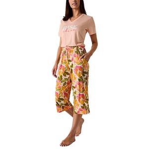 Floral print pajama pants with a relaxed fit, featuring a colorful pattern of orange, pink, and green hues. The waist is elasticized for comfort and includes two side pockets.