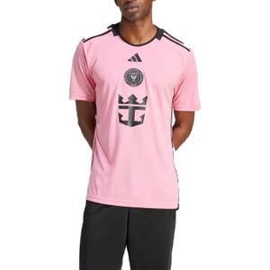 Pink Adidas Messi Miami Jersey with black accents; features Inter Miami CF logo and a bold crown design on the front, complemented by short sleeves and a comfortable fit.