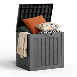 A black storage box with a wood panel design is open, revealing pillows and a folded blanket inside.