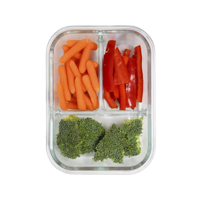 A glass container with three compartments holds baby carrots, sliced red bell peppers, and broccoli florets.