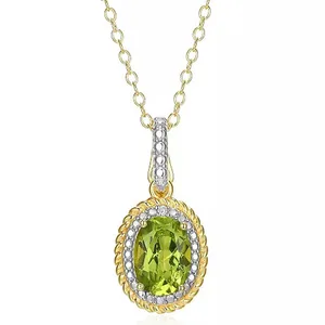 A necklace with a green oval gemstone pendant set in gold, featuring a decorative border embellished with smaller clear stones. The pendant hangs from a gold chain.