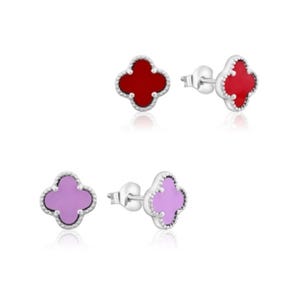 Two pairs of clover-shaped stud earrings with silver edging; one pair is red, and the other is purple.