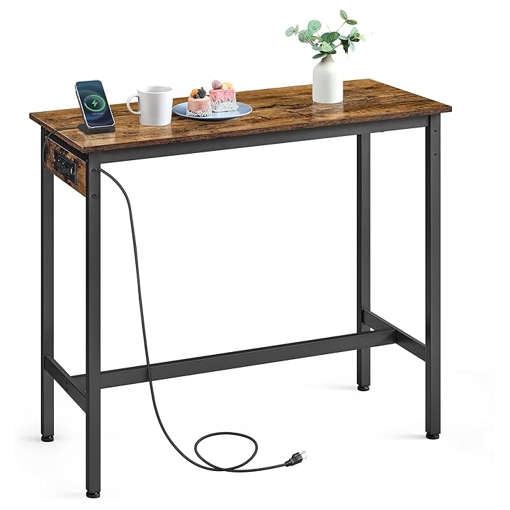 Wooden entryway table with black metal legs, featuring built-in charging ports. Includes a smartphone on a stand, a white cup, a plate with pastries, and a vase with greenery on top.