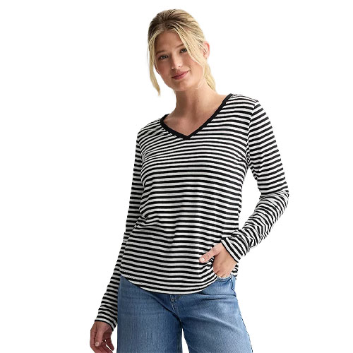 A woman wearing a black and white striped long-sleeve V-neck shirt paired with light blue jeans.