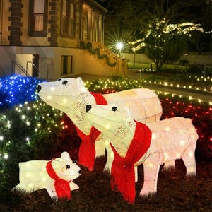 Decorative light-up polar bear figurines with red scarves, displaying a parent and cub.