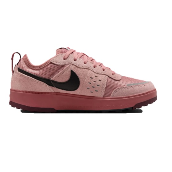 A pink and black Nike sneaker featuring a mesh and suede upper with a distinct swoosh logo, set on a pink sole.