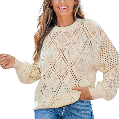 A woman wearing a cream-colored, diamond-patterned knit sweater with perforated sleeves, paired with blue jeans.