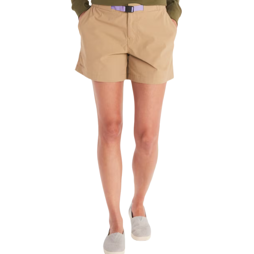Marmot Kodachrome Shorts are tan, featuring a built-in belt and side pockets, paired with a green top and gray slip-on shoes.
