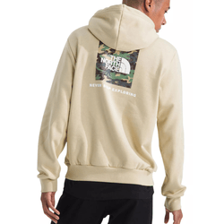 Tan hoodie with a camo-patterned North Face logo and \“Never Stop Exploring\“ text on the back, paired with black pants.