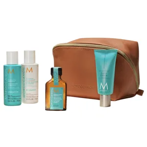 Moroccanoil travel set includes hydrating shampoo and conditioner (2.4 fl. oz. each), treatment oil, and hand cream, accompanied by a brown cosmetic bag.