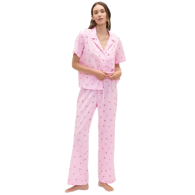 Pink pajama set with a short-sleeve button-up top and long pants, featuring a small floral pattern.