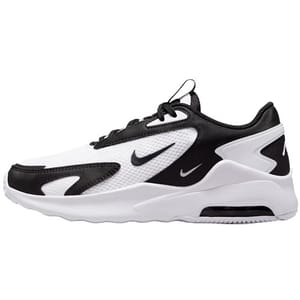 A black and white athletic sneaker with a prominent swoosh logo on the side, featuring a mesh and synthetic layered design with a thick cushioned sole.