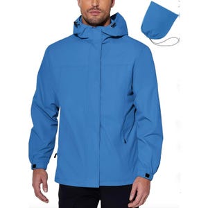 A man wearing a blue hooded jacket with a front zipper and pockets.