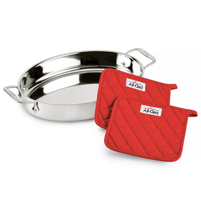 Stainless steel oval roasting pan with two red quilted potholders labeled \“All-Clad.\“