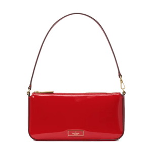 Red patent leather shoulder bag with a gold zipper and hardware, featuring a thin strap and a logo plaque on the front.