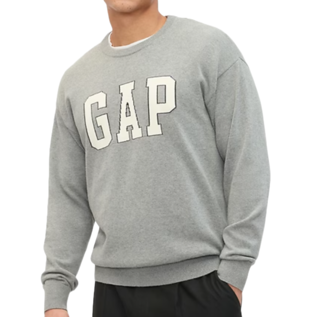 A grey sweatshirt featuring large white \“GAP\“ letters on the front, worn by a person.