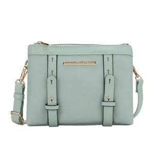 Mint green crossbody bag with gold hardware, including a zip closure and two front straps.