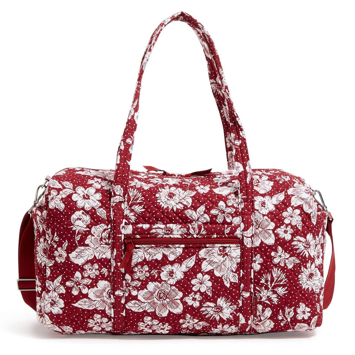 A red floral-patterned duffel bag with white flowers, featuring a zippered front pocket, two handles, and an adjustable shoulder strap.