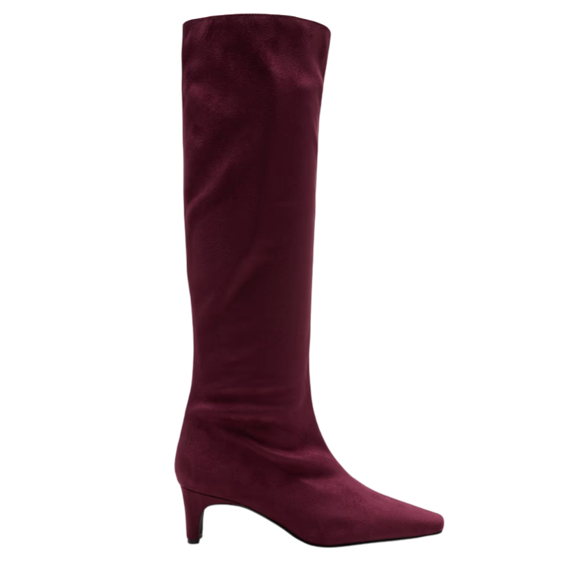 A burgundy knee-high boot with a pointed toe and low kitten heel, featuring a sleek, smooth texture.