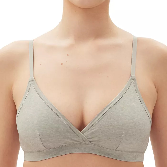 A light gray bralette with thin straps and full coverage cups, featuring a V-neckline and subtly visible seam lines.