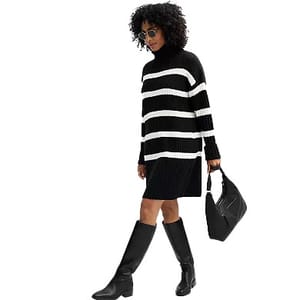 Black and white striped turtleneck sweater dress, knee-length, paired with knee-high black boots and a black handbag.