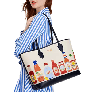The Kate Spade Spice it Up Large Tote features illustrations of various sauce bottles, including hot sauce, ketchup, and soy sauce, on a cream background with black trim and handles.