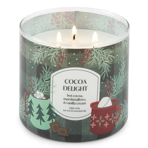Cocoa Delight candle with a triple wick features scents of hot cocoa, marshmallows, and vanilla cream. The design includes festive mugs and pine branches.