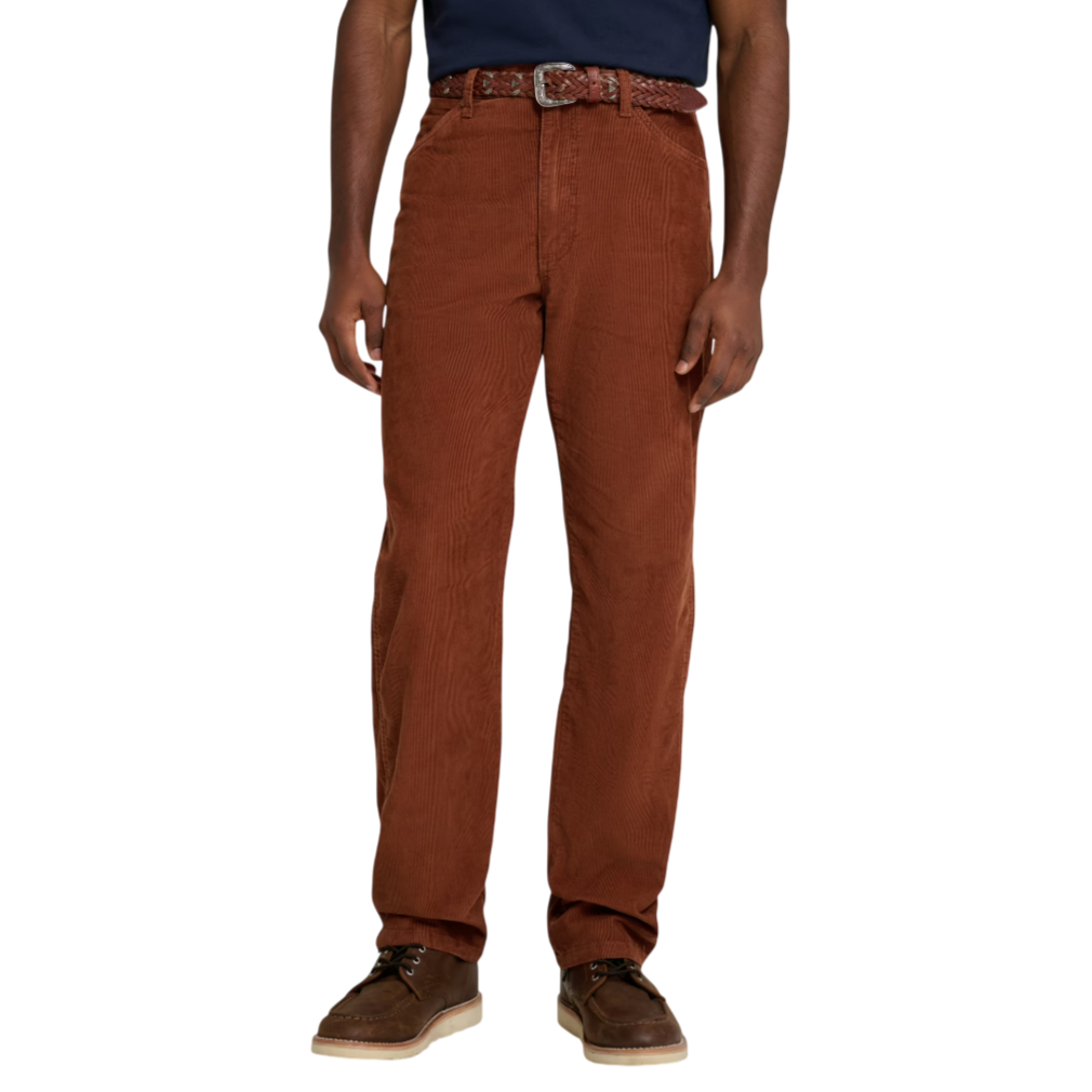 A person is wearing brown corduroy pants paired with a woven brown belt, dark shirt, and casual brown shoes with cream soles.
