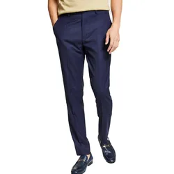 A person is wearing dark blue checkered dress pants with hands in pockets, paired with a beige shirt and blue loafers.