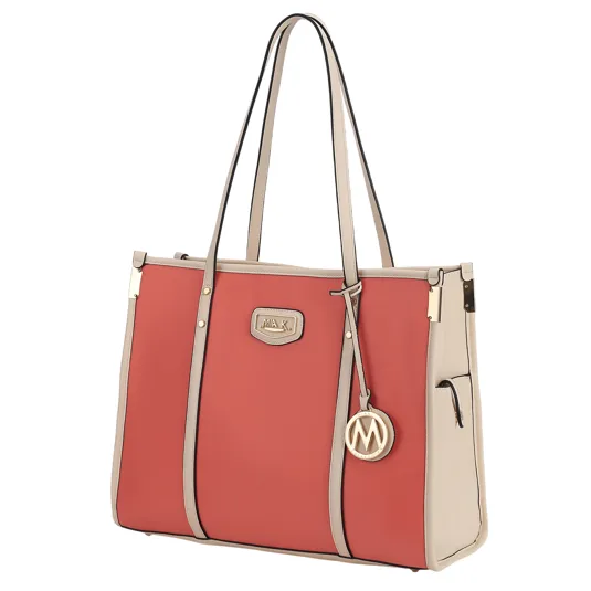 A two-tone tote bag featuring a coral front with beige accents, external pockets, gold hardware, and dual beige handles. A round gold emblem with an \“M\“ hangs from one handle.