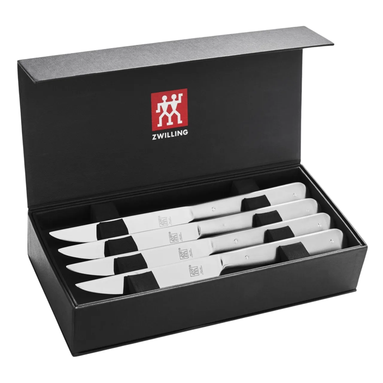Set of four Zwilling steak knives with stainless steel handles, displayed in a black box with the Zwilling logo.
