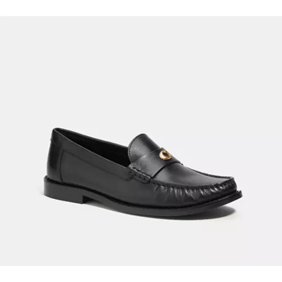 A single black leather loafer with a metal accent on the saddle.