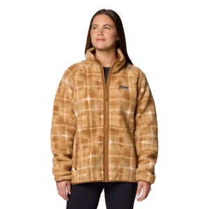 A woman is wearing a Columbia full-zip fleece jacket with a brown and white plaid pattern, paired with dark pants.