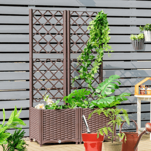 A garden trellis with climbing plants, planter boxes with various greenery, and gardening tools on a wooden deck.