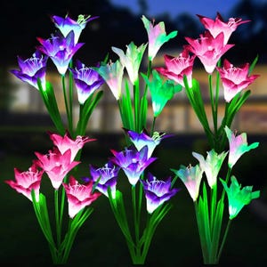 A collection of artificial lily flowers with LED lights in various colors.