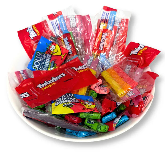 A bowl containing Twizzlers Twists and Jolly Rancher Gummies and hard candies in assorted colors.