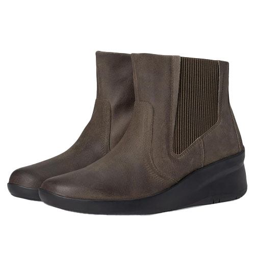 Brown ankle-length Clarks leather boots feature elastic side panels for easy wear and a slight wedge heel, suitable for both casual and semi-formal settings.