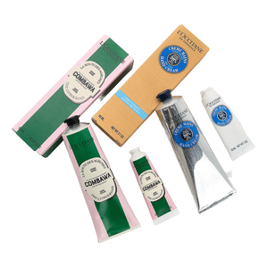 L'Occitane Holiday Hand Cream Quartet includes Combawa and Shea hand creams, each in two sizes, featuring citrus and shea butter scents, packaged in green with pink accents and natural cardboard with blue highlights, respectively.