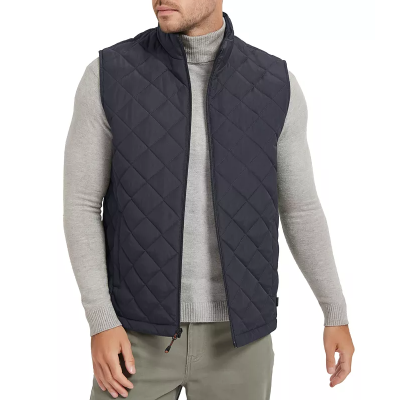 A man is wearing a gray turtleneck sweater and a quilted navy blue vest.